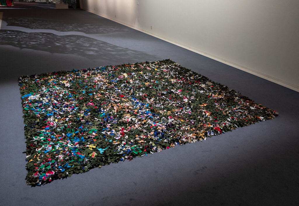 Reynier Leyva Novo b. 1983, Cuba Untitled (Militares y Civiles), 2018 Rug made by 12 unemployed civilians from Párraga, La Habana, from clothes used by military and civilians in Cuba 150 × 150 inches