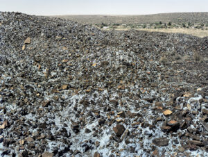 David Goldblatt b. 1930, d. 2018, South Africa Highly carcinogenic blue asbestos waste on the Owendale Asbestos Mine tailings dump, near Postmasburg, Northern Cape. The prevailing wind was in the direction of the mine official’s houses at right. 21 December 2002 (4_8739), 2002 Digital C-print in pigment inks on cotton rag paper 44 × 53 inches