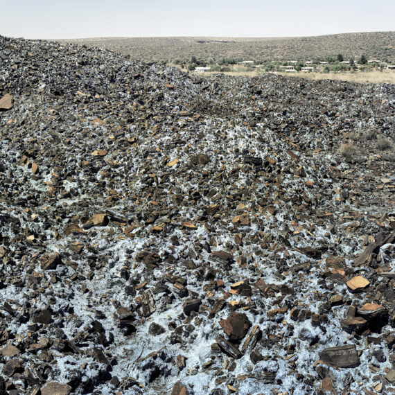 David Goldblatt b. 1930, d. 2018, South Africa Highly carcinogenic blue asbestos waste on the Owendale Asbestos Mine tailings dump, near Postmasburg, Northern Cape. The prevailing wind was in the direction of the mine official’s houses at right. 21 December 2002 (4_8739), 2002 Digital C-print in pigment inks on cotton rag paper 44 × 53 inches