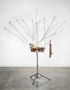 Abraham Cruzvillegas b. 1968, Mexico Topógrafos, 2003 Shot glasses, bongos, drum hardware, steel rods, Colombian pod, leather rattle, and cowbell 84 x 76 x 79 inches